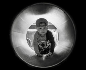 kid in tube tunnel
